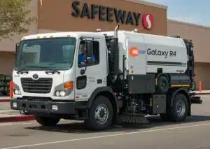 Street sweeping truck cleaning a parking lot – One Stop Property Services