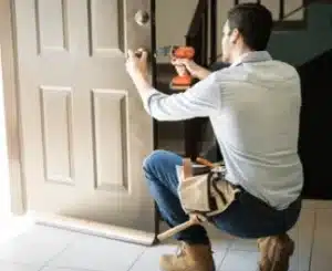 Handyman repairing a door lock – One Stop Property Services
